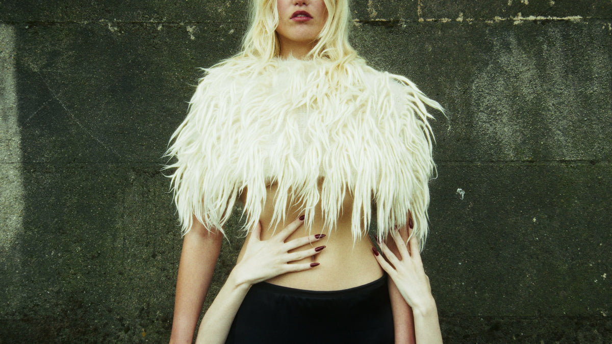 Adelina Bernard pre-campaign Like the Peeling of a Pomegranate woman in wool scarf with hands wrapped around her torso