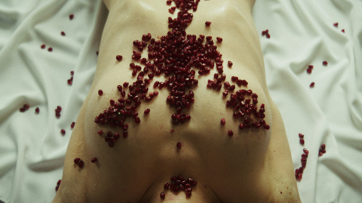 Adelina Bernard pre-campaign Like the Peeling of a Pomegranate bare upper body with pomegranate seeds