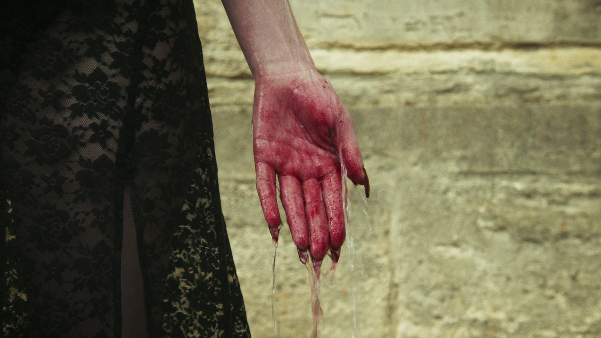Adelina Bernard pre-campaign Like the Peeling of a Pomegranate red-stained hand with water dripping