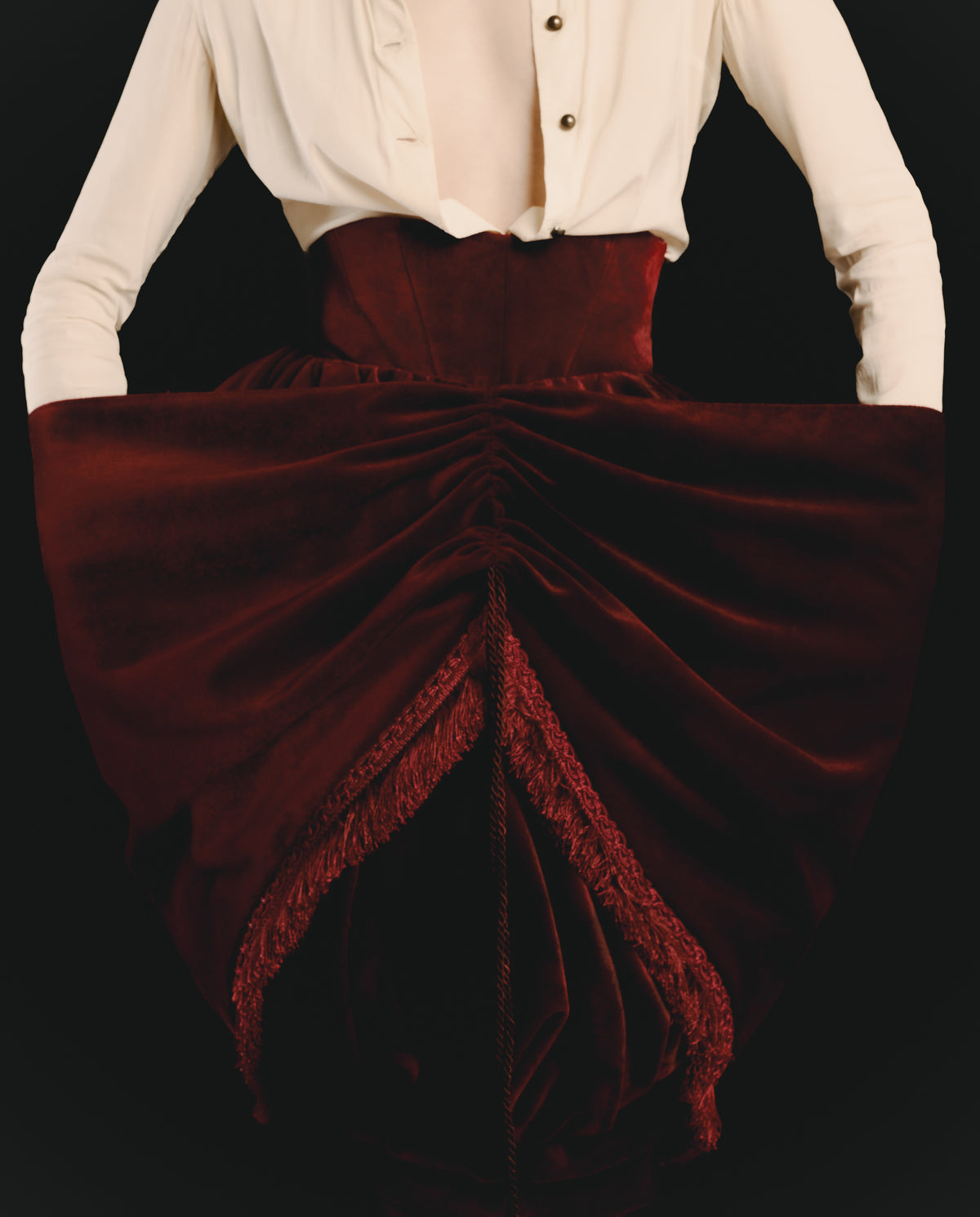 Adelina Bernard SS25 Pulling Strings campaign Close up of front, Red velvet skirt with a white blouse on a black background