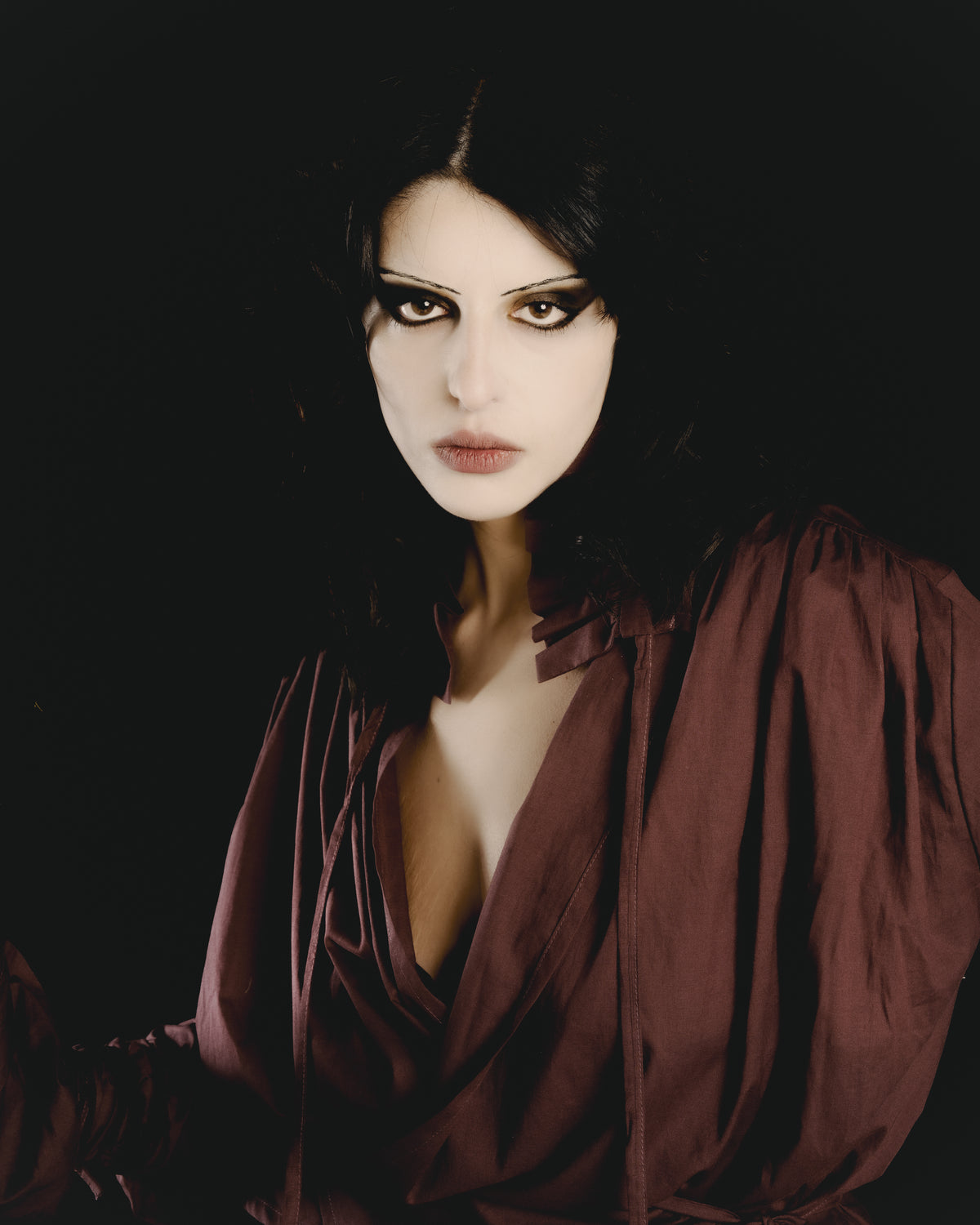 Adelina Bernard SS25 Pulling Strings campaign close-up of woman wearing a aubergine coloured blouse with strings