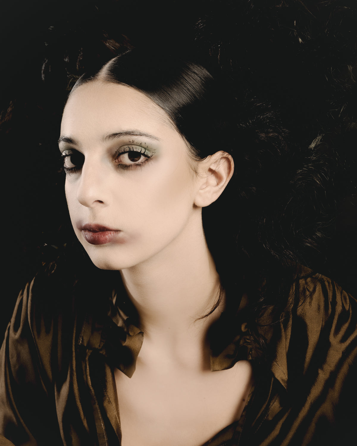 Adelina Bernard SS25 Pulling Strings campaign close-up of woman in bronze blouse with dramatic hair and make-up 