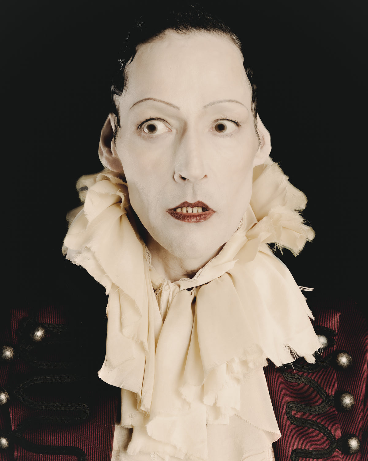Adelina Bernard SS25 Pulling Strings campaign close-up portrait with theatrical expression and ruffled collar