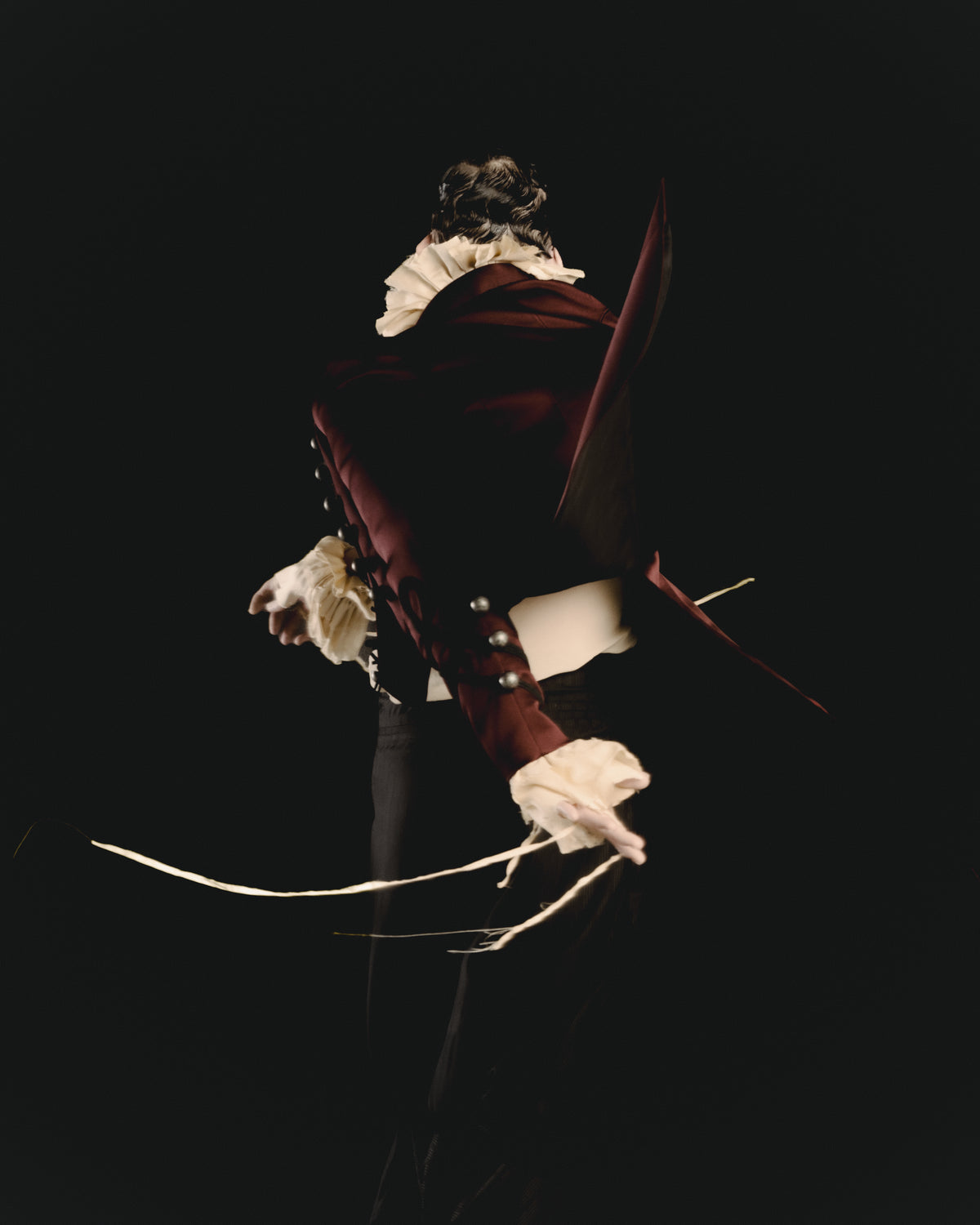 Adelina Bernard SS25 Pulling Strings campaign man turning dramatically with strings flying