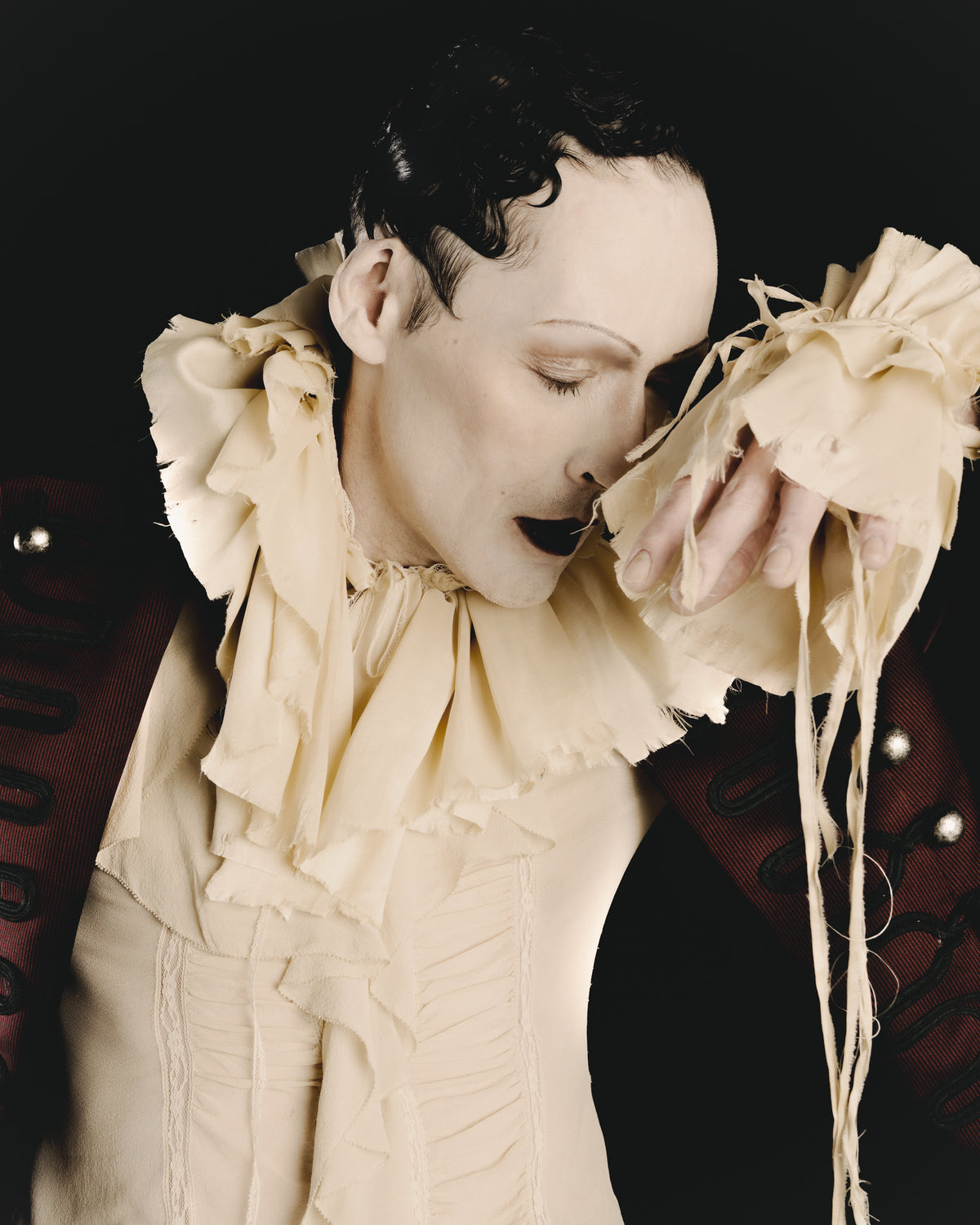 Adelina Bernard SS25 Pulling Strings campaign close-up portrait with theatrical expression and ruffled blouse